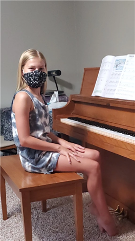 A person sitting at a piano

Description automatically generated with medium confidence