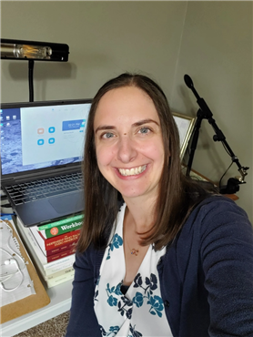 A person smiling in front of a computer

Description automatically generated with medium confidence